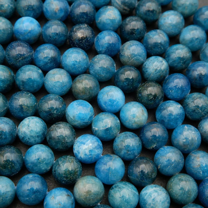 Round polished blue apatite beads.