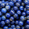 Blue round lapis lazuli beads with calcite and pyrite inclusions.