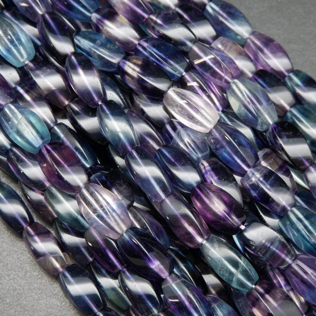 Twisted barrel shape multicolor fluorite beads.