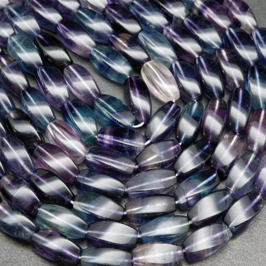 Twisted barrel shape multicolor fluorite beads.