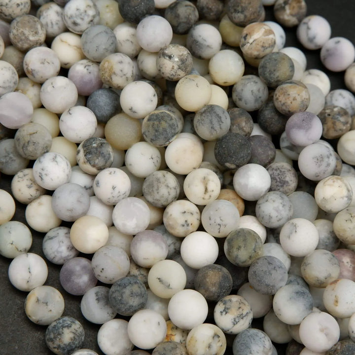 White dendritic opal beads.
