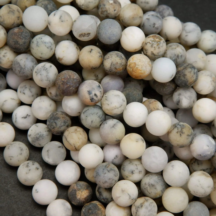 White dendritic opal beads.