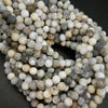 White dendritic opal beads.