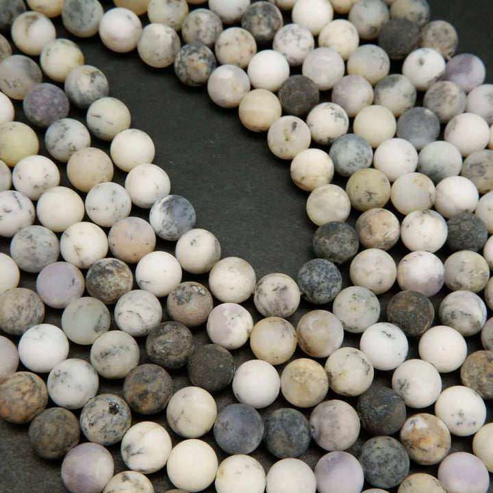 White dendritic opal beads.
