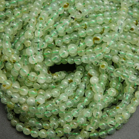 Green prehnite bead with epidote inclusions.