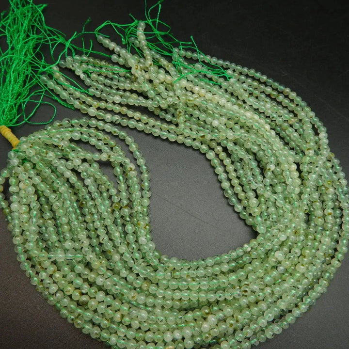 Green prehnite bead with epidote inclusions.