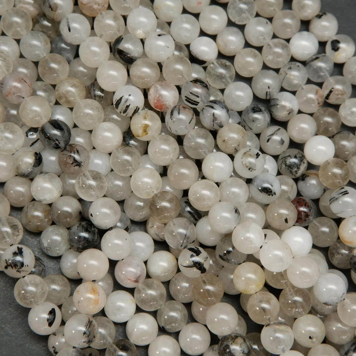Cloudy milky colored tourmalated quartz beads. Quartz beads with tourmaline inclusions.