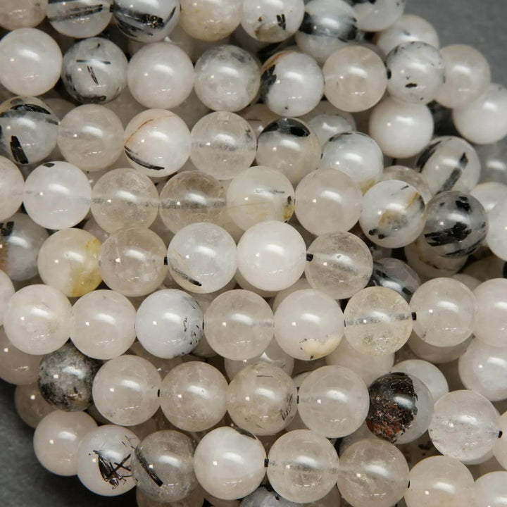 Cloudy milky colored tourmalated quartz beads. Quartz beads with tourmaline inclusions.