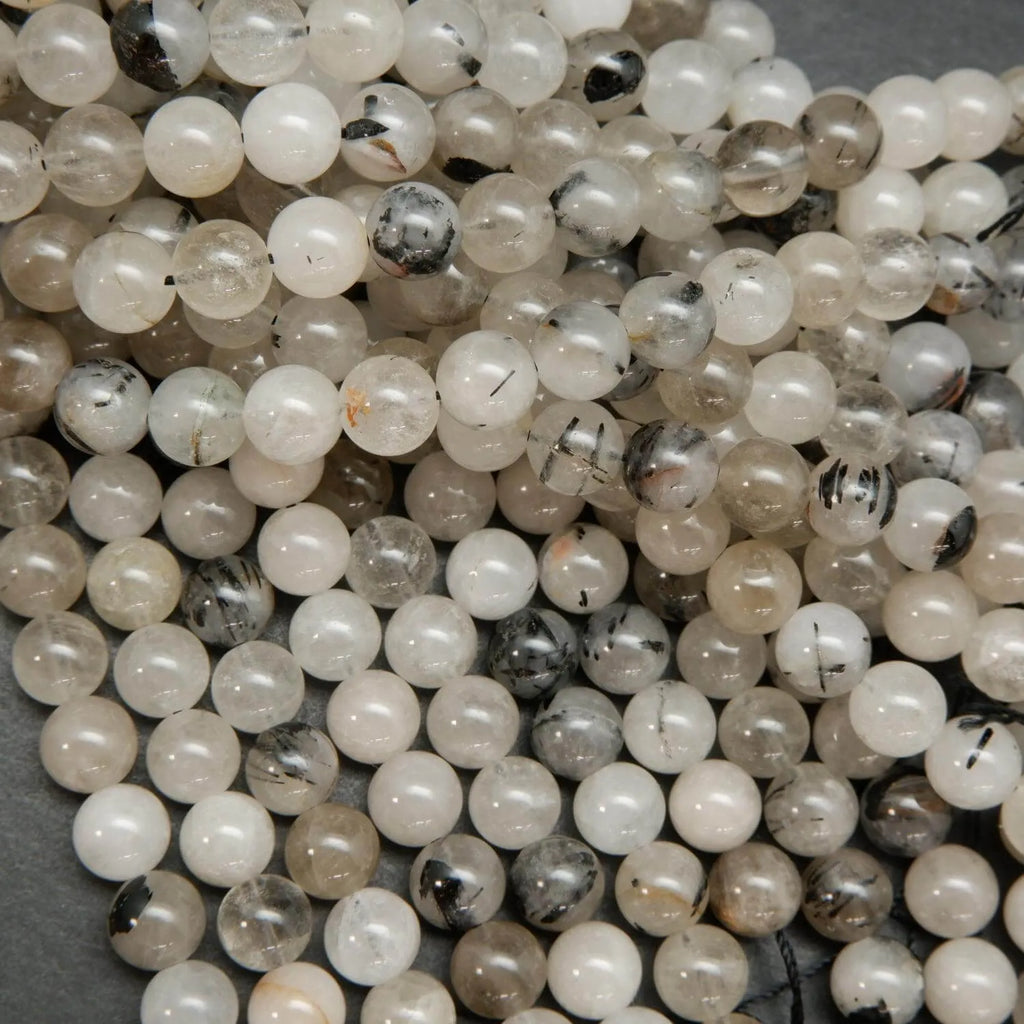 Cloudy milky colored tourmalated quartz beads. Quartz beads with tourmaline inclusions.