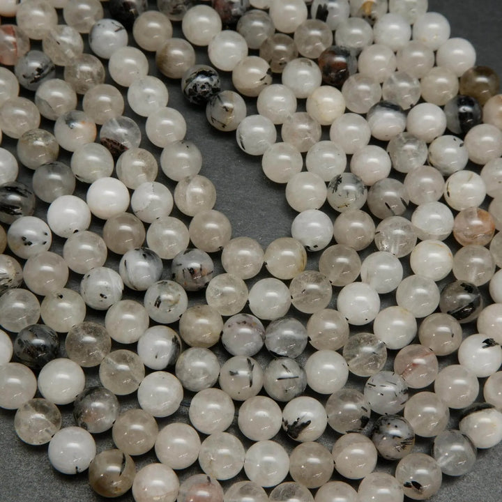 Cloudy milky colored tourmalated quartz beads. Quartz beads with tourmaline inclusions.