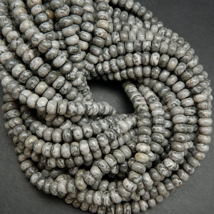 Swirling patterned silver lace agate rondelle beads.