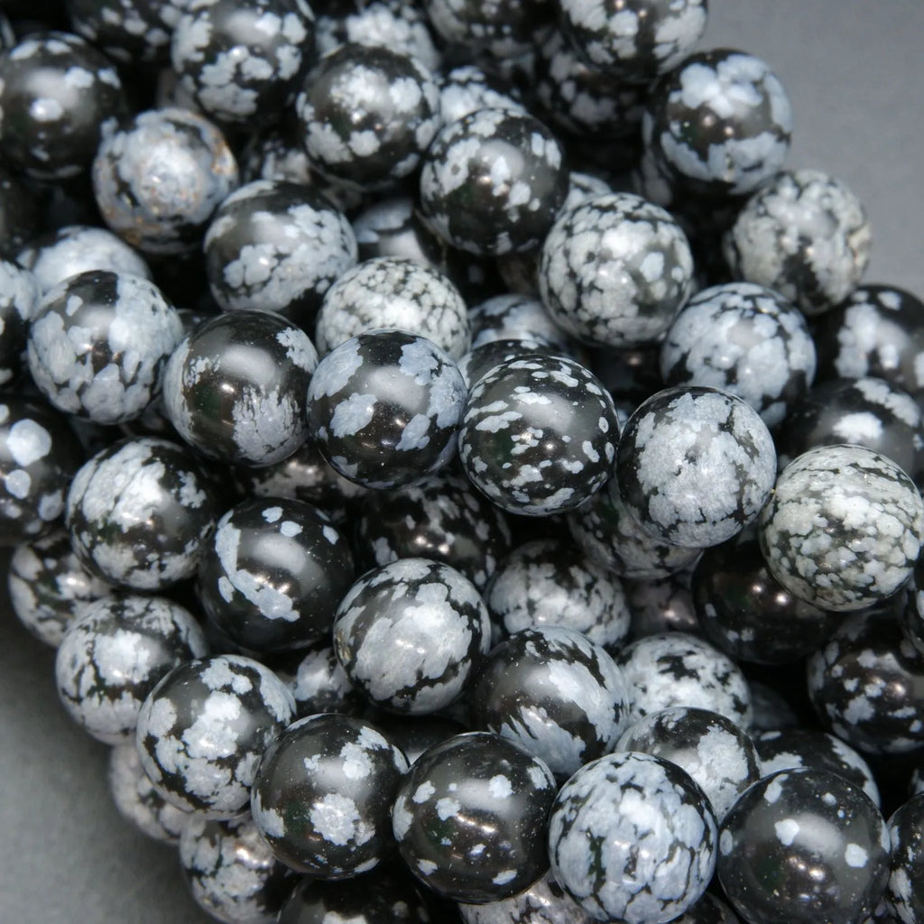 Snowflake obsidian beads. Black matrix with grey ash flakes. 
