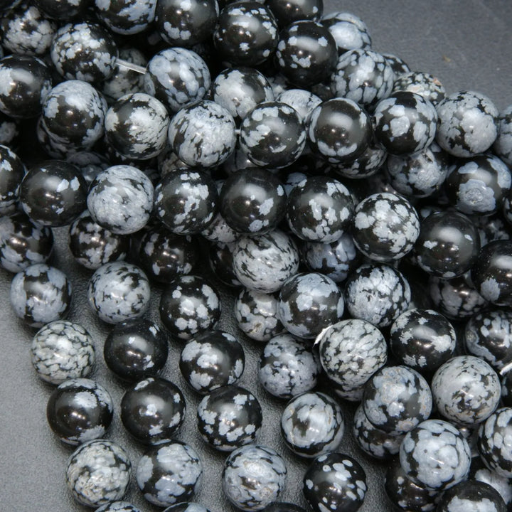 Snowflake obsidian beads. Black matrix with grey ash flakes. 