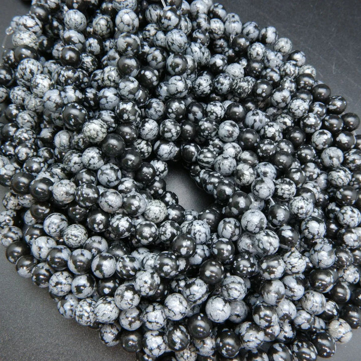 Snowflake obsidian beads. Black matrix with grey ash flakes. 