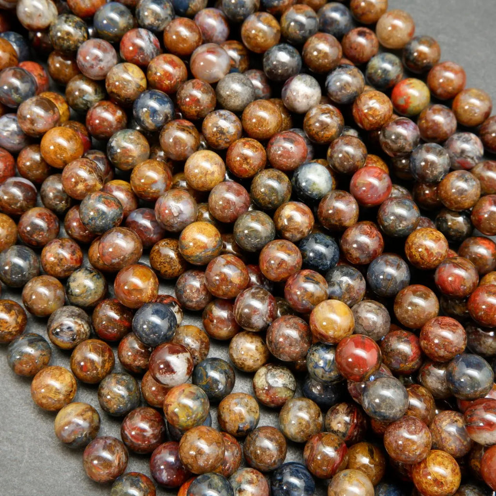 Brown, blue, and red round polished pietersite beads.