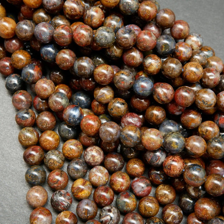 Brown, blue, and red round polished pietersite beads.