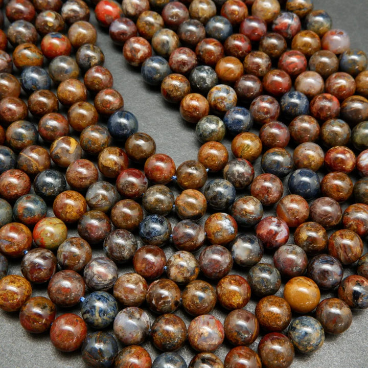 Brown, blue, and red round polished pietersite beads.
