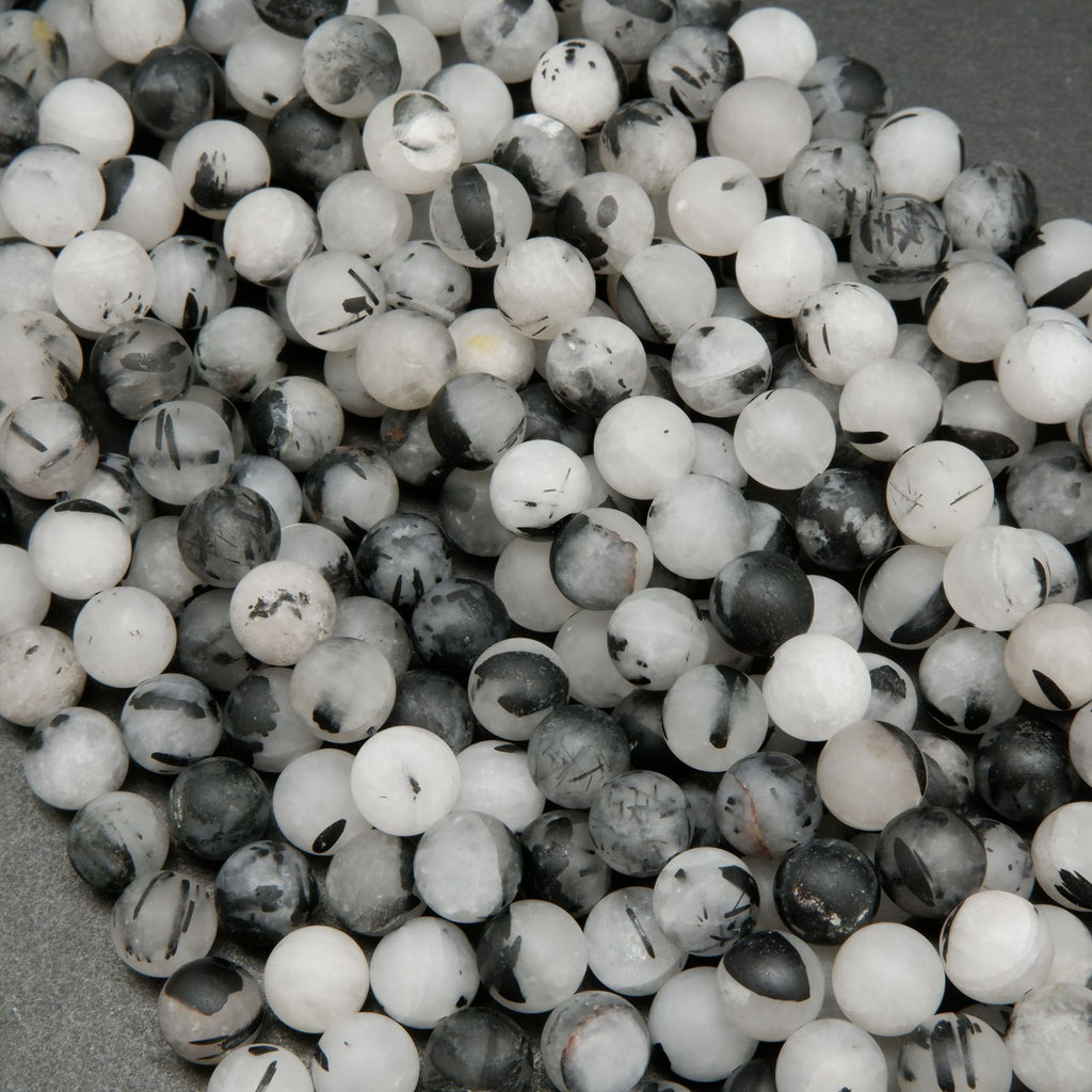 White quartz beads with black tourmaline needle like inclusions.
