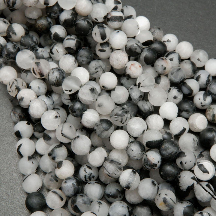 White quartz beads with black tourmaline needle like inclusions.