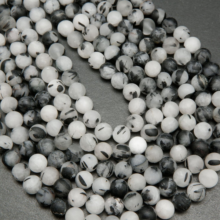 White quartz beads with black tourmaline needle like inclusions.