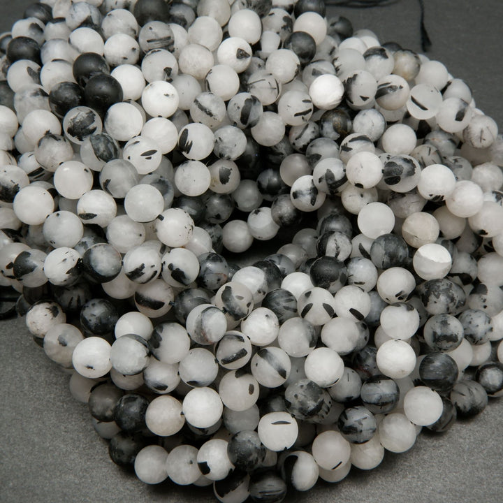 White quartz beads with black tourmaline needle like inclusions.