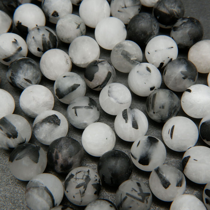 White quartz beads with black tourmaline needle like inclusions.