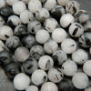 White quartz beads with black tourmaline needle like inclusions.