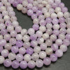 Lavender amethyst beads. Pale purple color with white cloudiness mixed in.