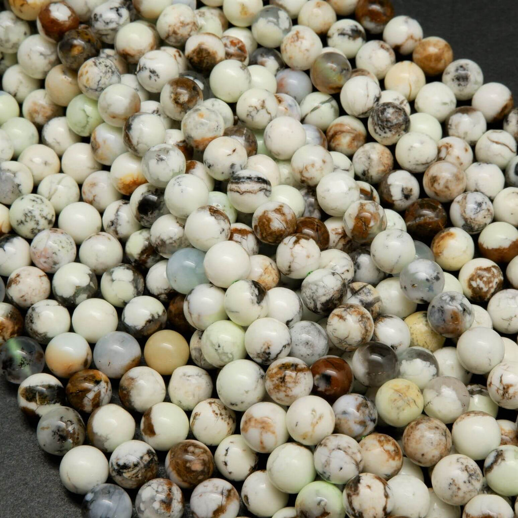 Polished round lemon chrysoprase beads with brown matrix.