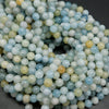 Multicolor aquamarine beads. Polished round blight to dark blue beads with the occasional light yellow beads mixed in.