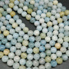 Multicolor aquamarine beads. Polished round blight to dark blue beads with the occasional light yellow beads mixed in.
