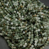 Faceted green rutilated quartz beads.