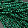 Dark green microfaceted round malachite beads.