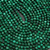 Dark green microfaceted round malachite beads.