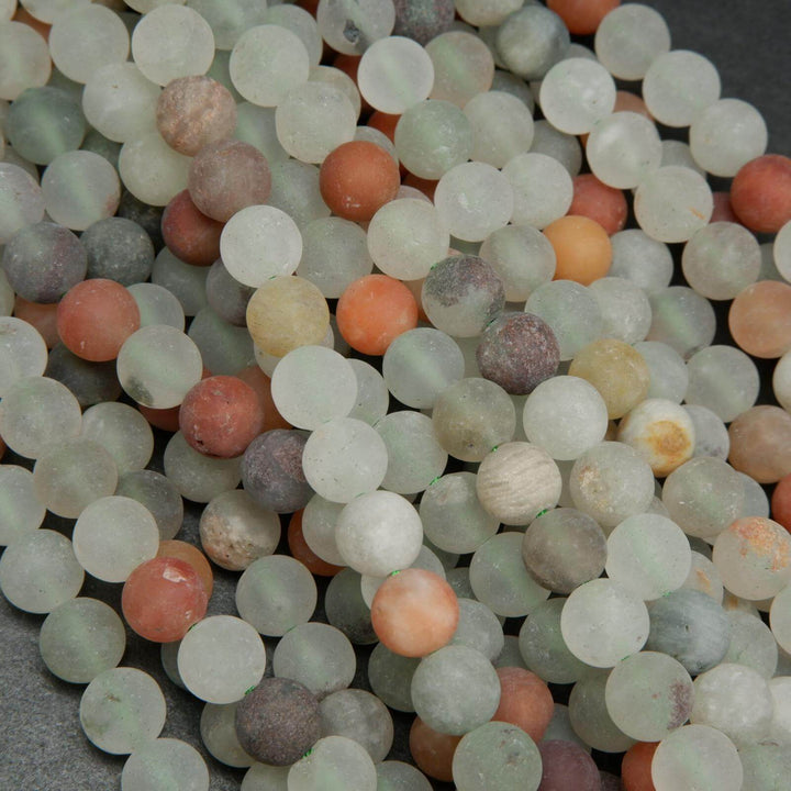 Matte finish frosted white and red phantom quartz beads.