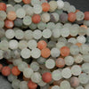 Matte finish frosted white and red phantom quartz beads.