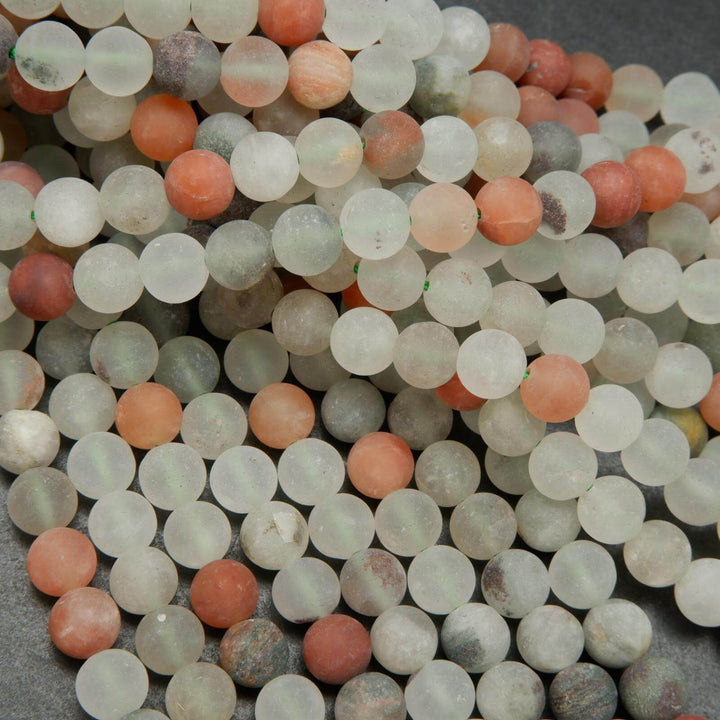 Matte finish frosted white and red phantom quartz beads.