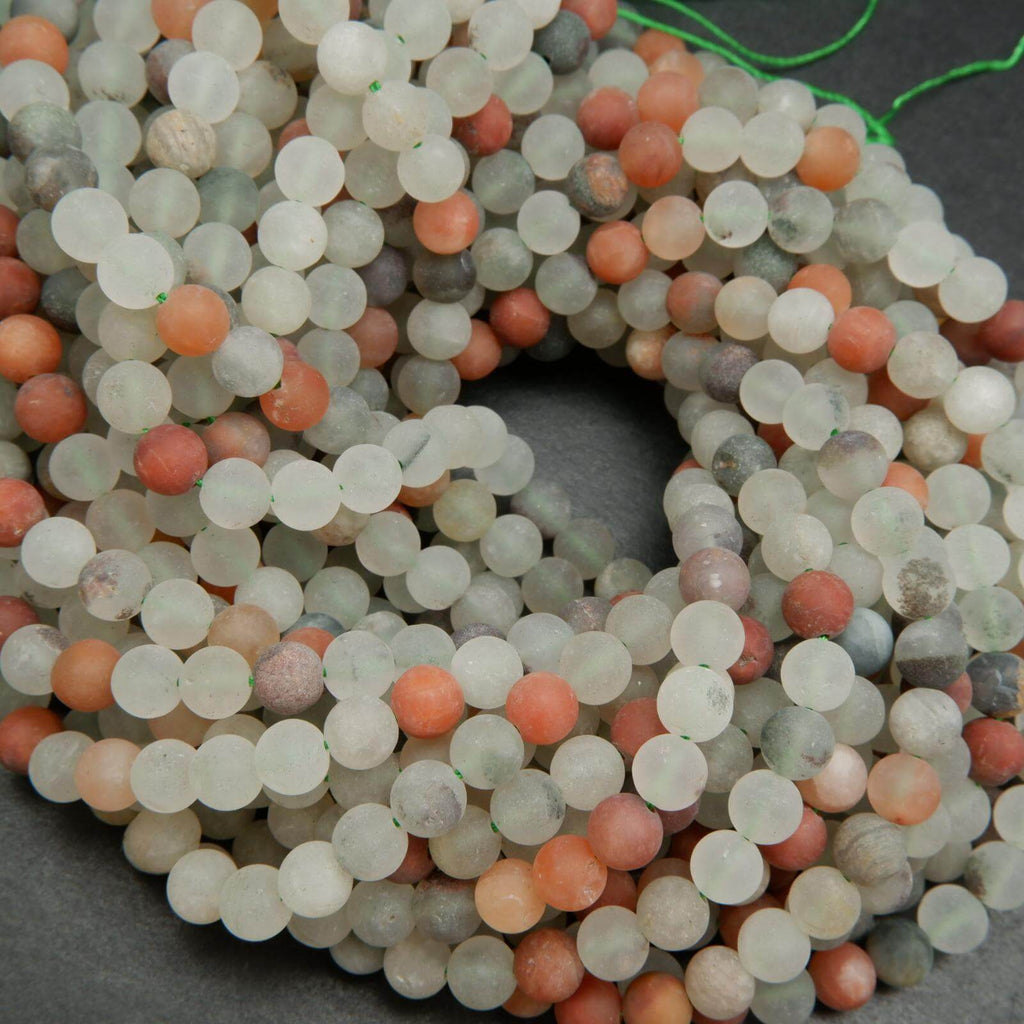 Matte finish frosted white and red phantom quartz beads.