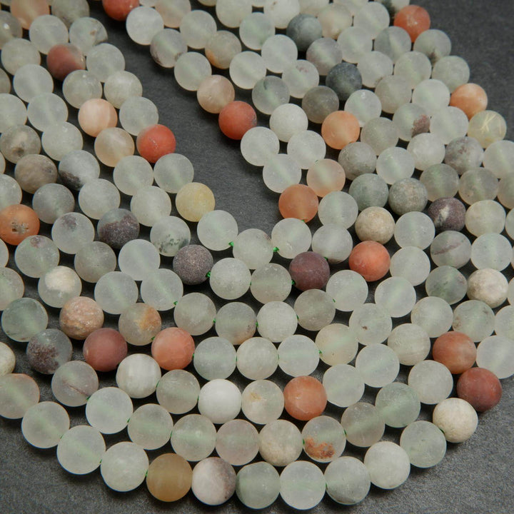 Matte finish frosted white and red phantom quartz beads.