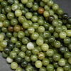 Green mixed hue jade beads. Round polished beads for making handmade jewelry. 