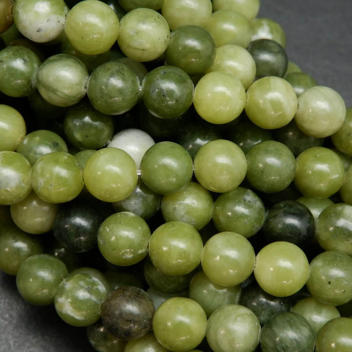 Green mixed hue jade beads. Round polished beads for making handmade jewelry. 