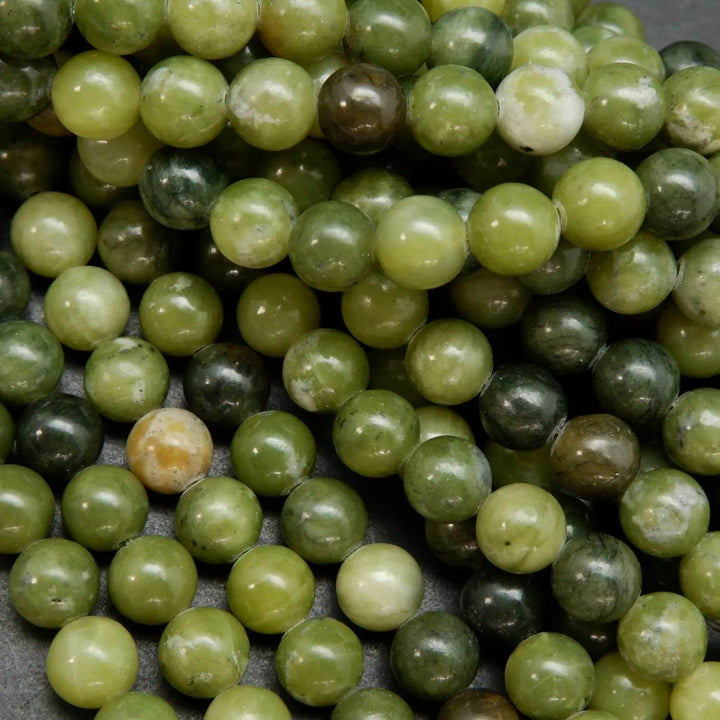 Green mixed hue jade beads. Round polished beads for making handmade jewelry. 