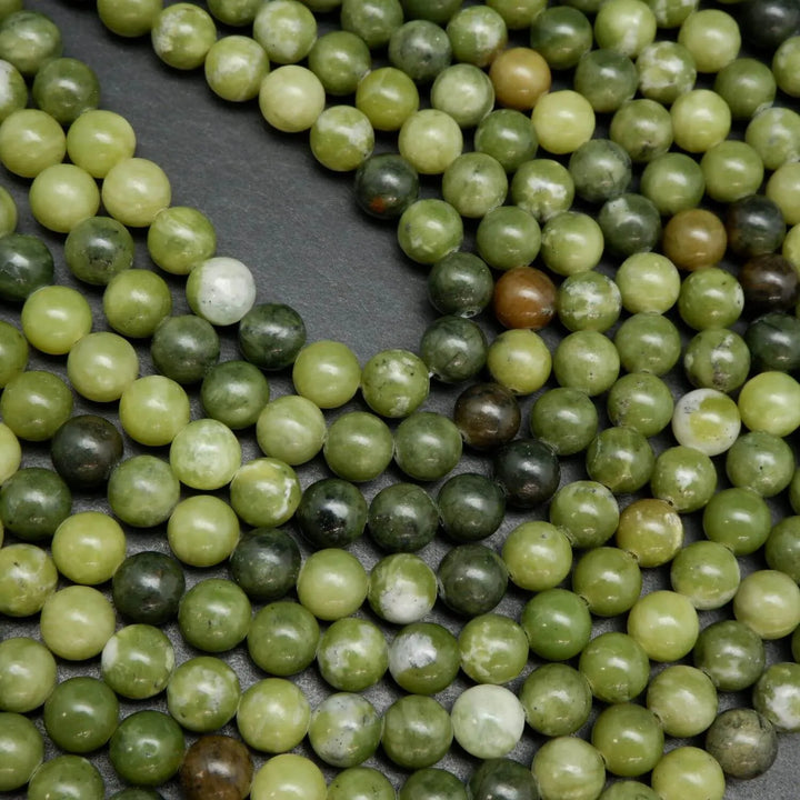 Green mixed hue jade beads. Round polished beads for making handmade jewelry. 