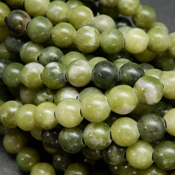 Mixed dark and light olive green hues in these olivine jade large hole round beads.