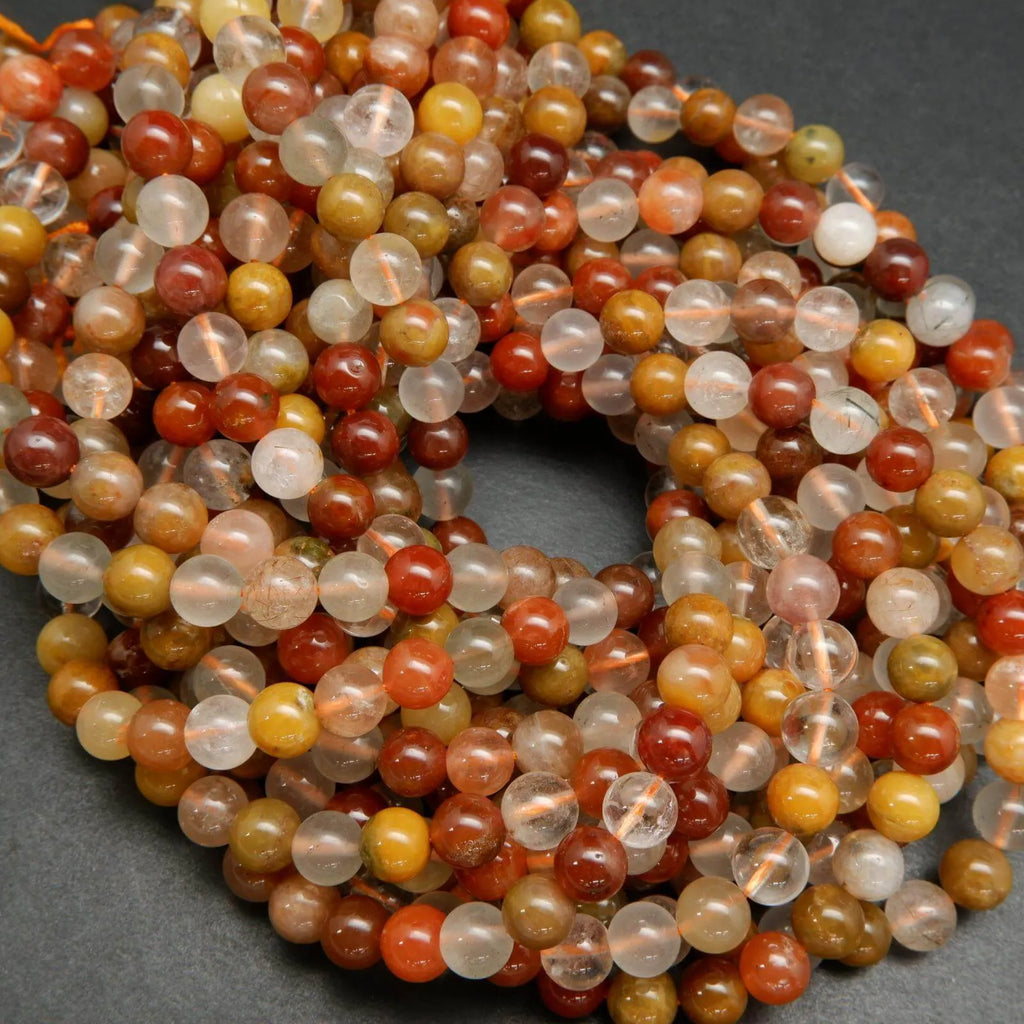 Mixed red and golden yellow rutilated phantom quartz beads.