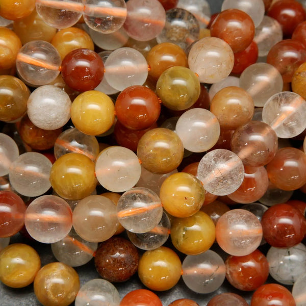 Mixed red and golden yellow rutilated phantom quartz beads.