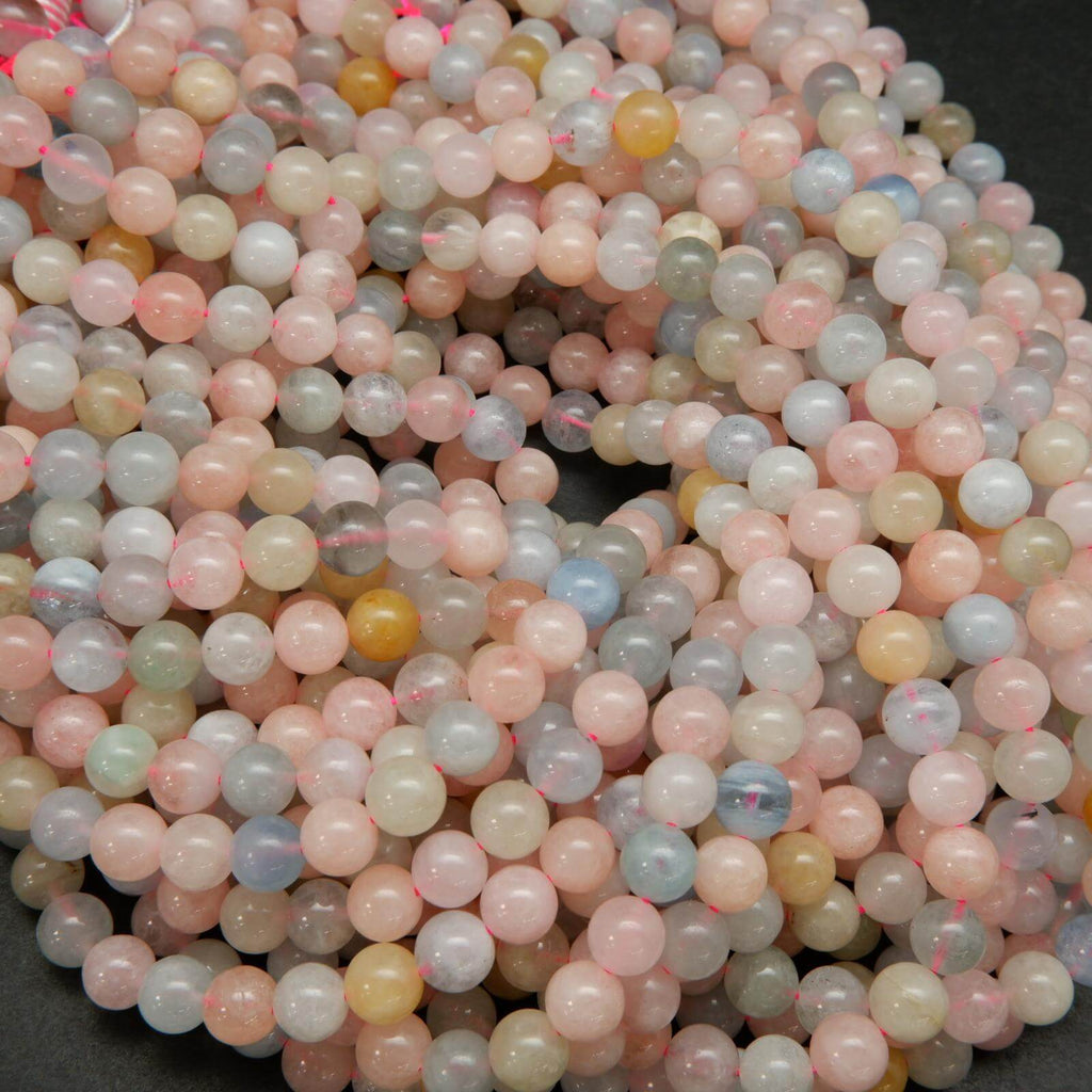 Pink, blue, green, and yellow polished round beryl beads.