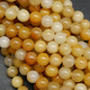 Yellow Jade A · Smooth · Round · 6mm, 8mm, 10mm · Large Hole · 1/2 Strand