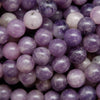 Round polished purple lepidolite beads.