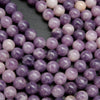 Round polished purple lepidolite beads.